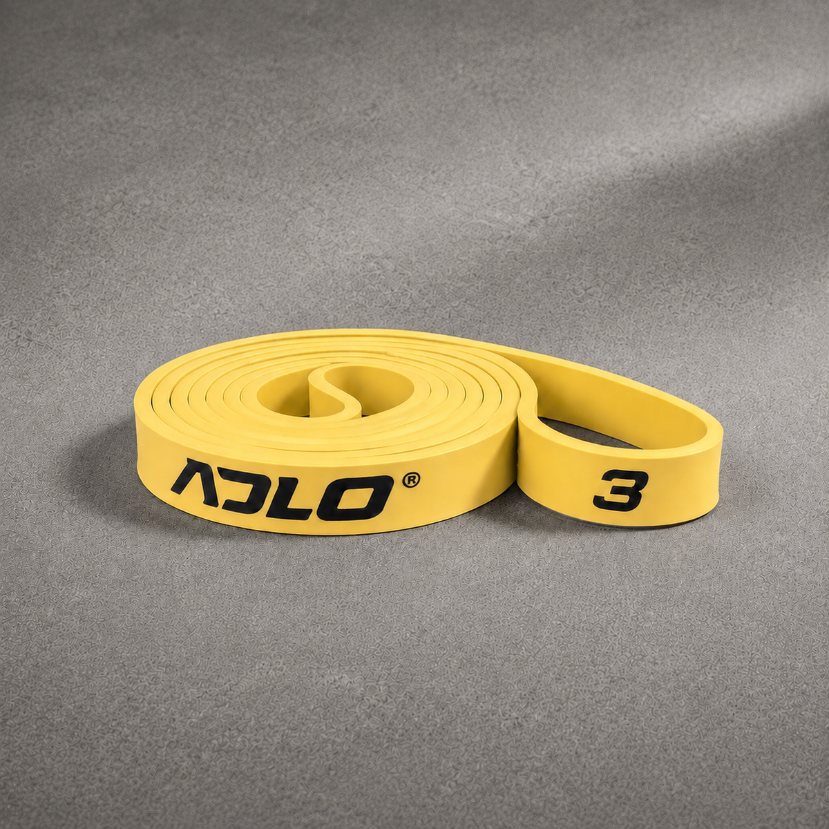 ADLO #3 Band - moderate resistance gold natural latex resistance band coiled on concrete