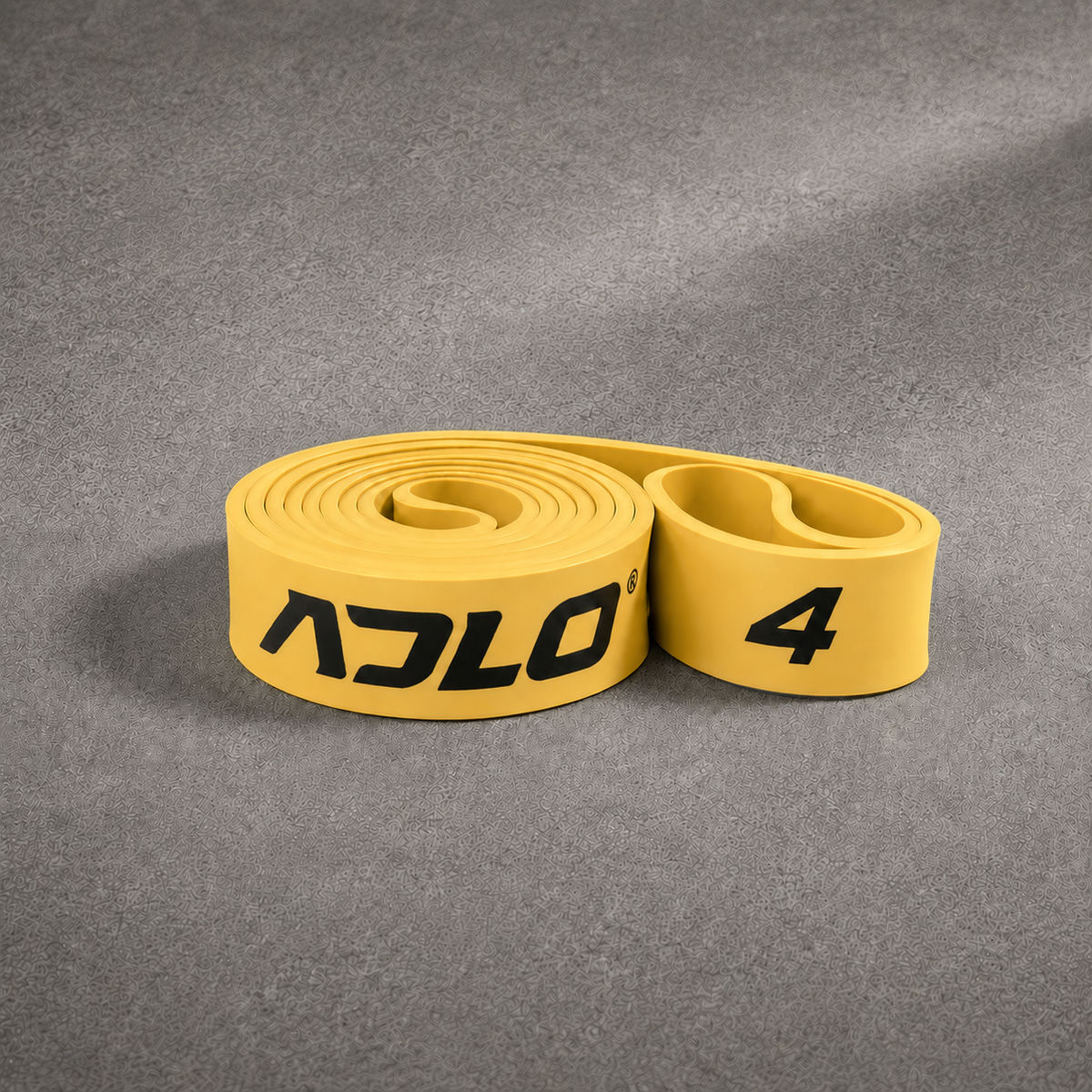 ADLO #4 Band - moderate to heavy resistance gold natural latex resistance band coiled on concrete